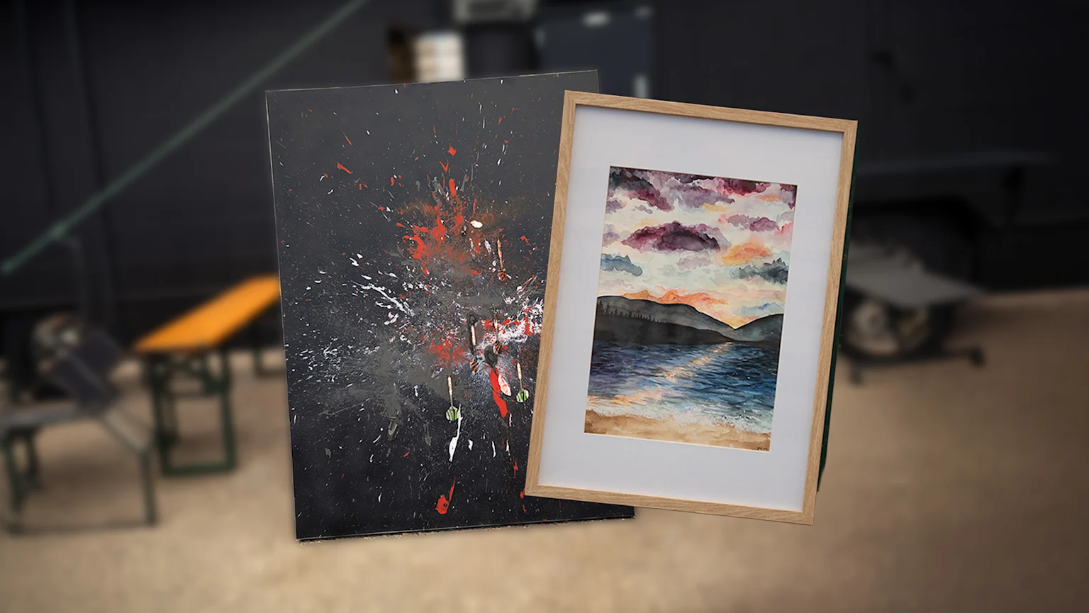 Two distinct paintings are presented side-by-side: an abstract dark canvas with red and white splatters and darts, and a framed watercolor landscape depicting a sunset over water and mountains.