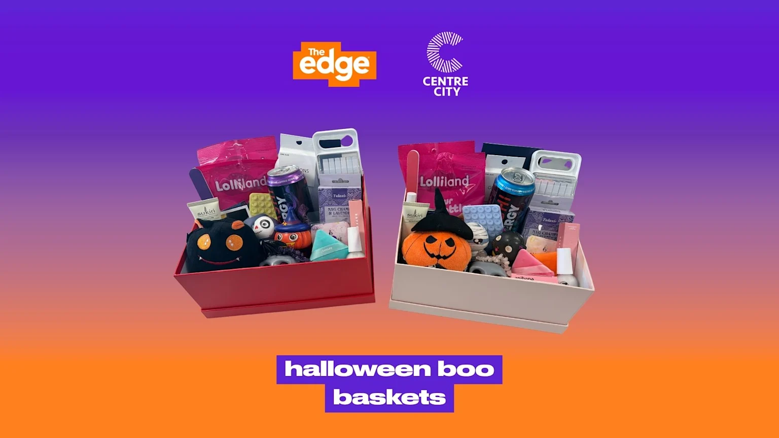 Two open gift baskets, one red and one light, filled with Halloween-themed plush toys, candy, energy drinks, and beauty products, on a purple to orange background with 'The Edge' and 'Centre City' logos, and 'halloween boo baskets' text.