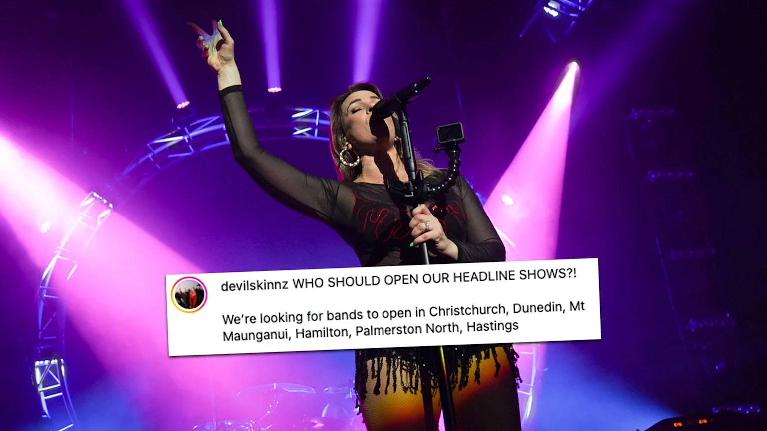 Jennie from Devilskin performing on stage with purple lights