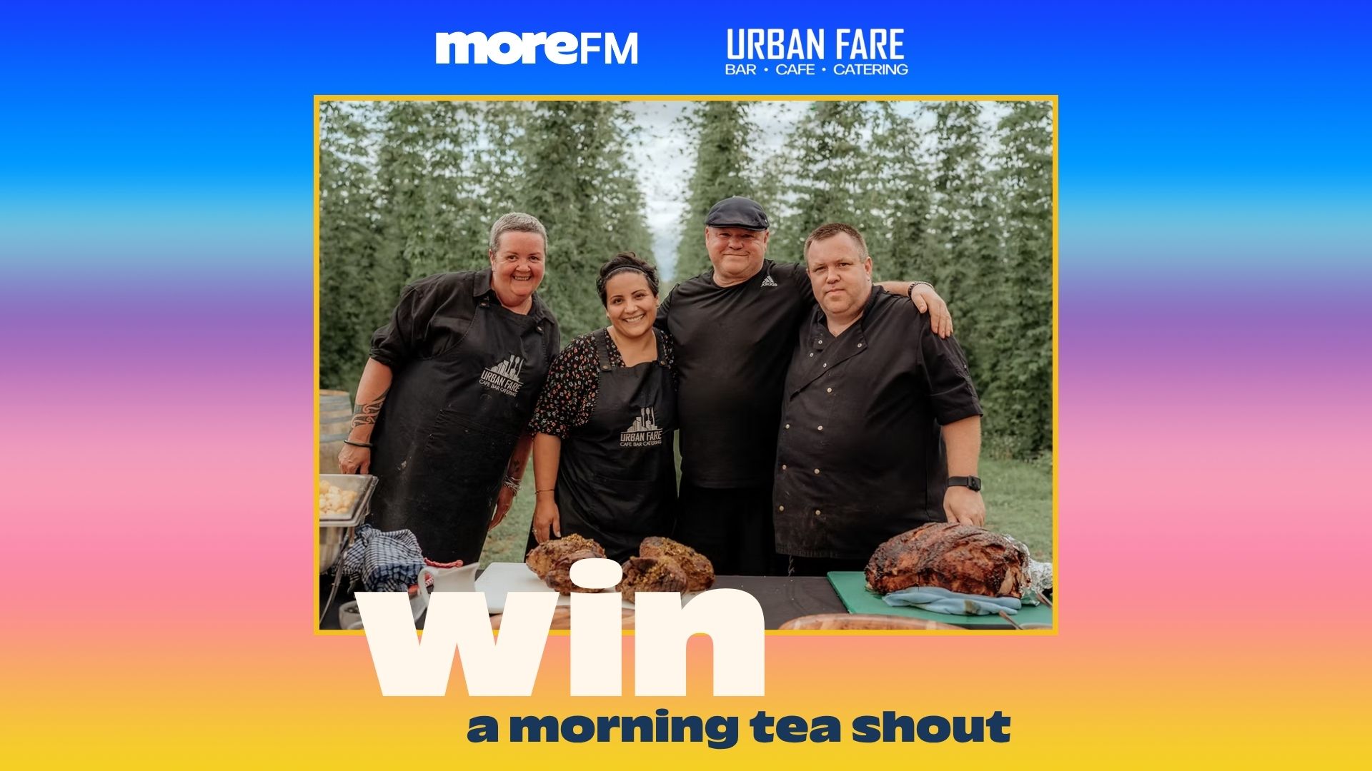 Four catering staff from Urban Fare smile behind a table with food, including roasted meats, with text overlays 'moreFM URBAN FARE' and 'win a morning tea shout'.