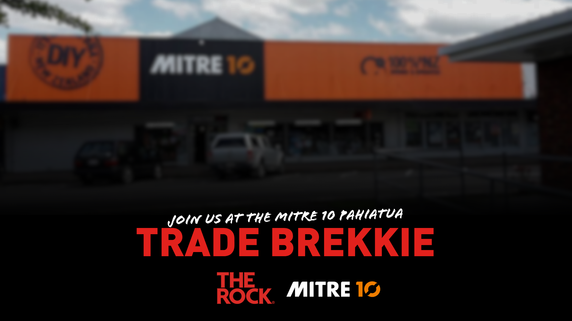 A blurred exterior shot of a Mitre 10 store in Pahiatua with overlay text inviting to a "Trade Brekkie" and showing "The Rock" and "Mitre 10" logos.