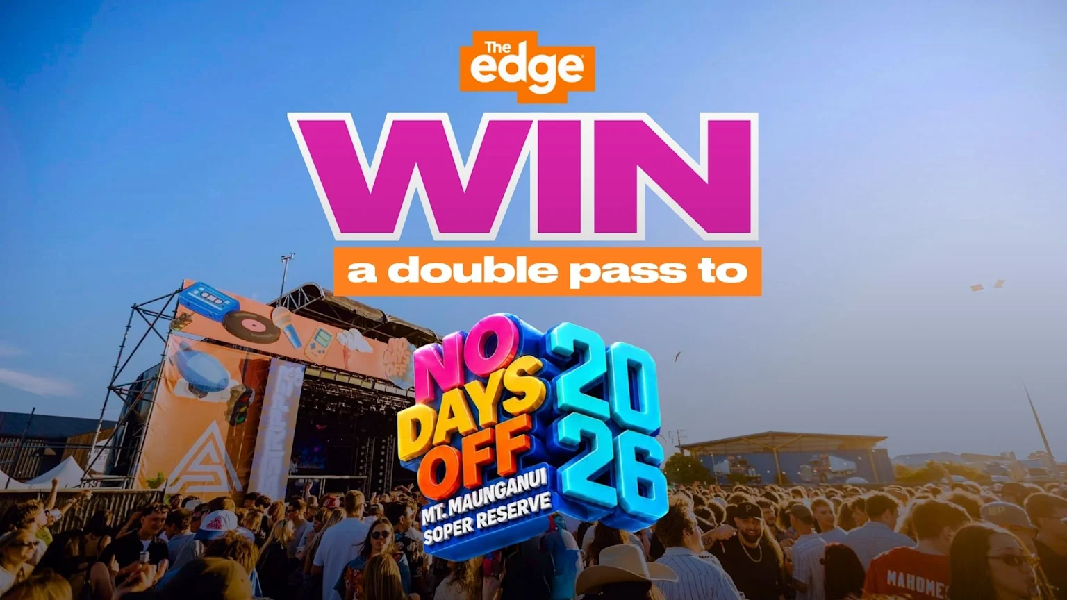 A lively outdoor festival with a crowd, a stage, and a large overlay promoting 'The Edge: WIN a double pass to NO DAYS OFF 2026 MT. MAUNGANUI SOPER RESERVE' against a blue sky.