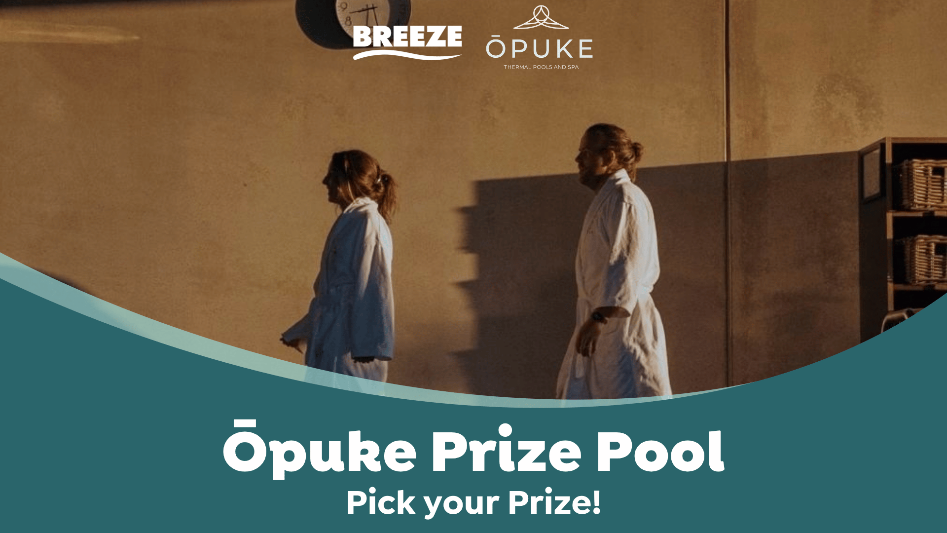 Two people in white robes walk past a wall with logos for Breeze and Ōpuke Thermal Pools and Spa, above a teal banner reading 'Ōpuke Prize Pool, Pick your Prize!'.