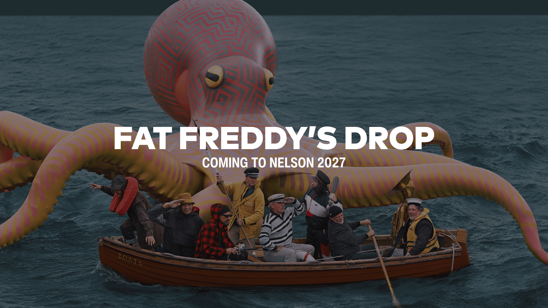 A large red and yellow patterned octopus sculpture in the ocean is behind a rowboat marked 'B.O.A.T.S' with eight men in nautical outfits, and 'FAT FREDDY'S DROP' text.