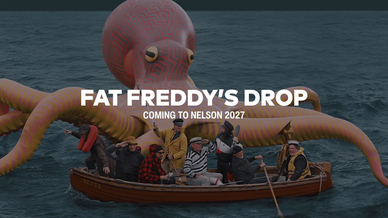 A large red and yellow patterned octopus sculpture in the ocean is behind a rowboat marked 'B.O.A.T.S' with eight men in nautical outfits, and 'FAT FREDDY'S DROP' text.