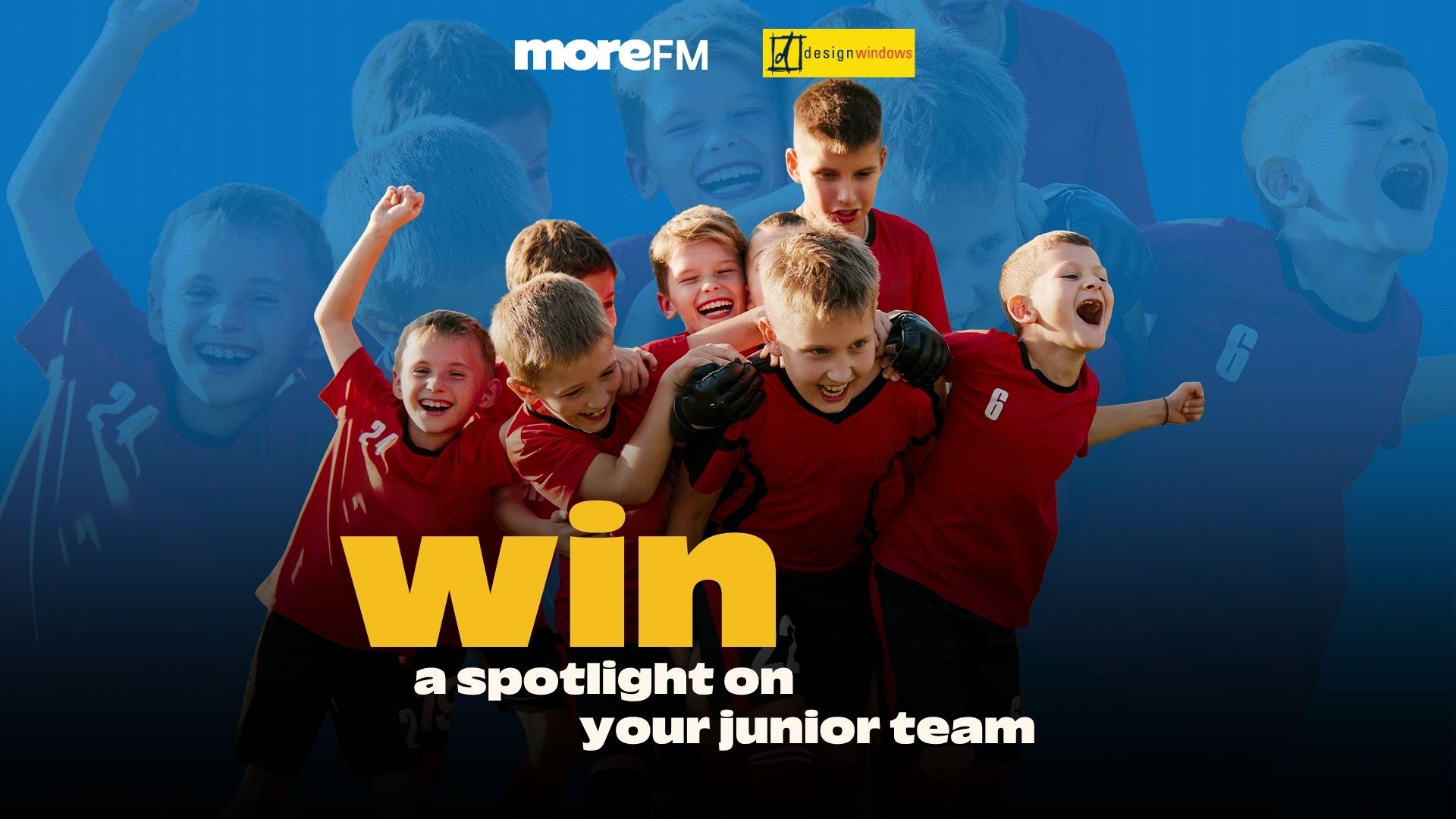 A group of joyful junior soccer players in red jerseys huddle and celebrate, with "moreFM" and "designwindows" logos and promotional text "win a spotlight on your junior team."