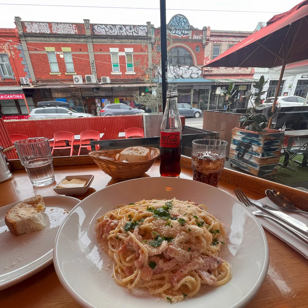 Pasta meal with Coke at street cafe