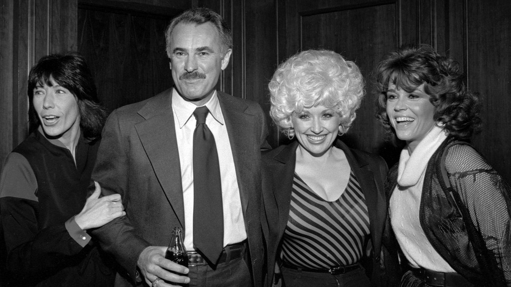 Lily Tomlin, Dabney Coleman, Dolly Parton, and Jane Fonda are shown smiling and posing together.