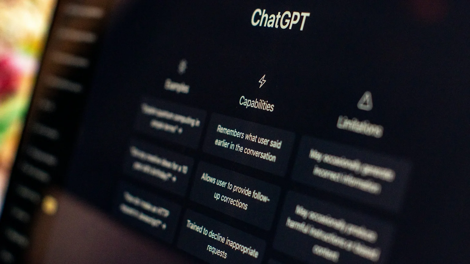 A screen displays the ChatGPT interface, clearly showing "Capabilities" like remembering conversations, accepting corrections, and declining inappropriate requests, with blurry "Limitations" also visible.