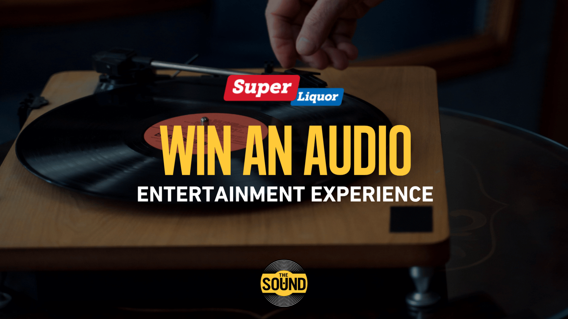 A hand places a needle on a vinyl record on a wooden turntable, with 'Super Liquor' and 'THE SOUND' logos and 'WIN AN AUDIO ENTERTAINMENT EXPERIENCE' text overlaid.