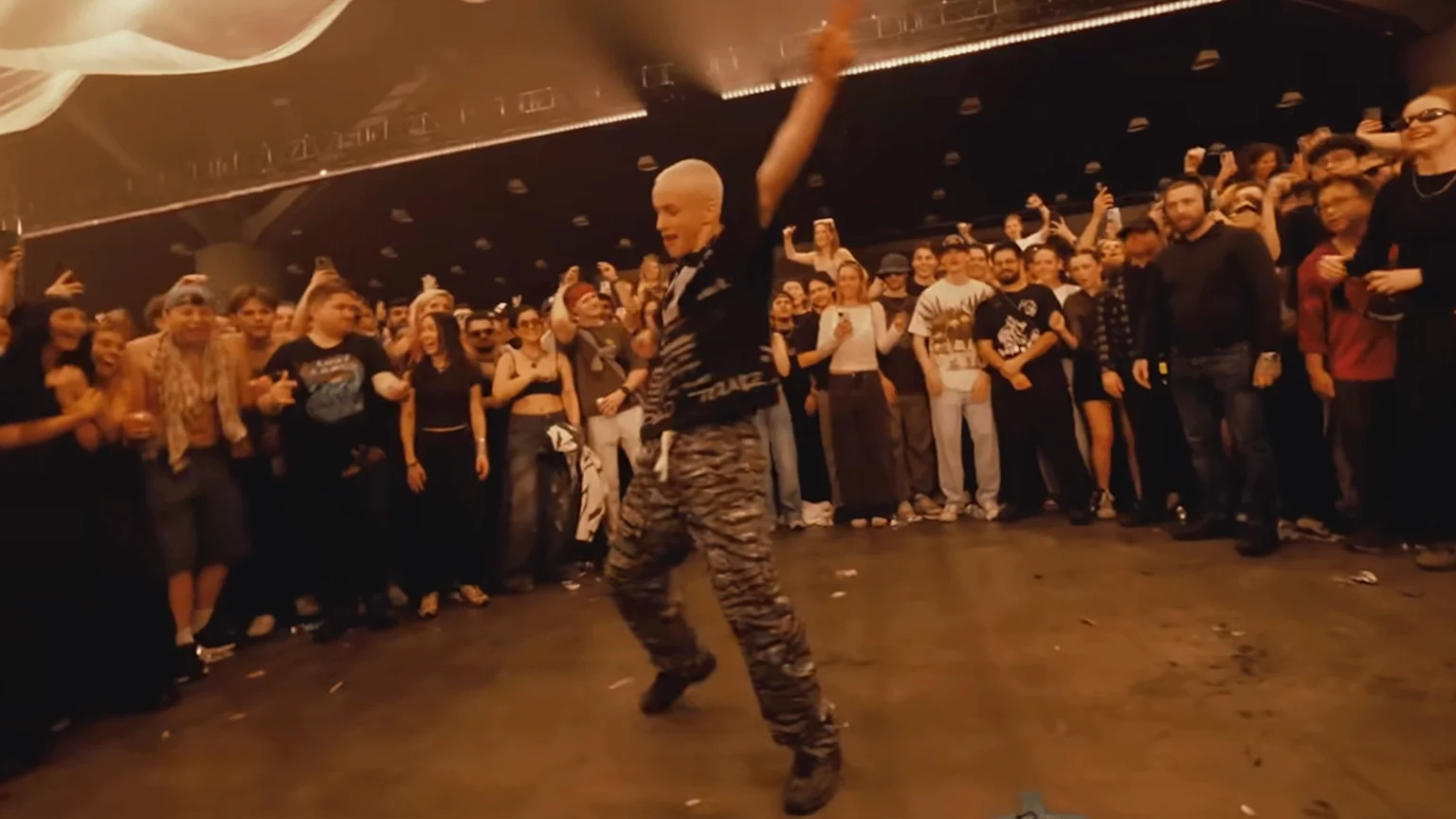 Teen dancer in middle of freestyle circle.