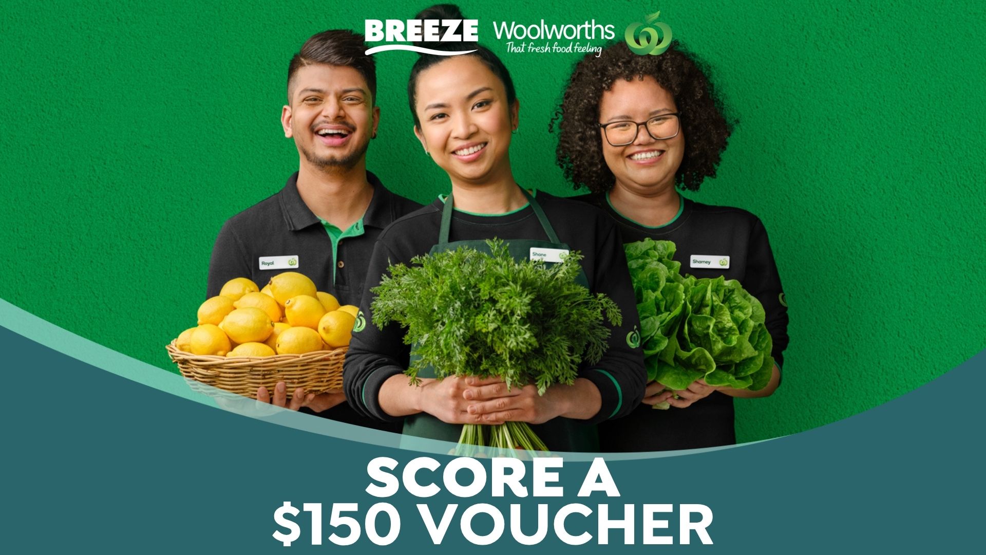Three happy Woolworths employees in green uniforms, with arms outstretched, stand in a fresh produce aisle, surrounded by vegetables, with text "WIN A $150 VOUCHER" prominently displayed.