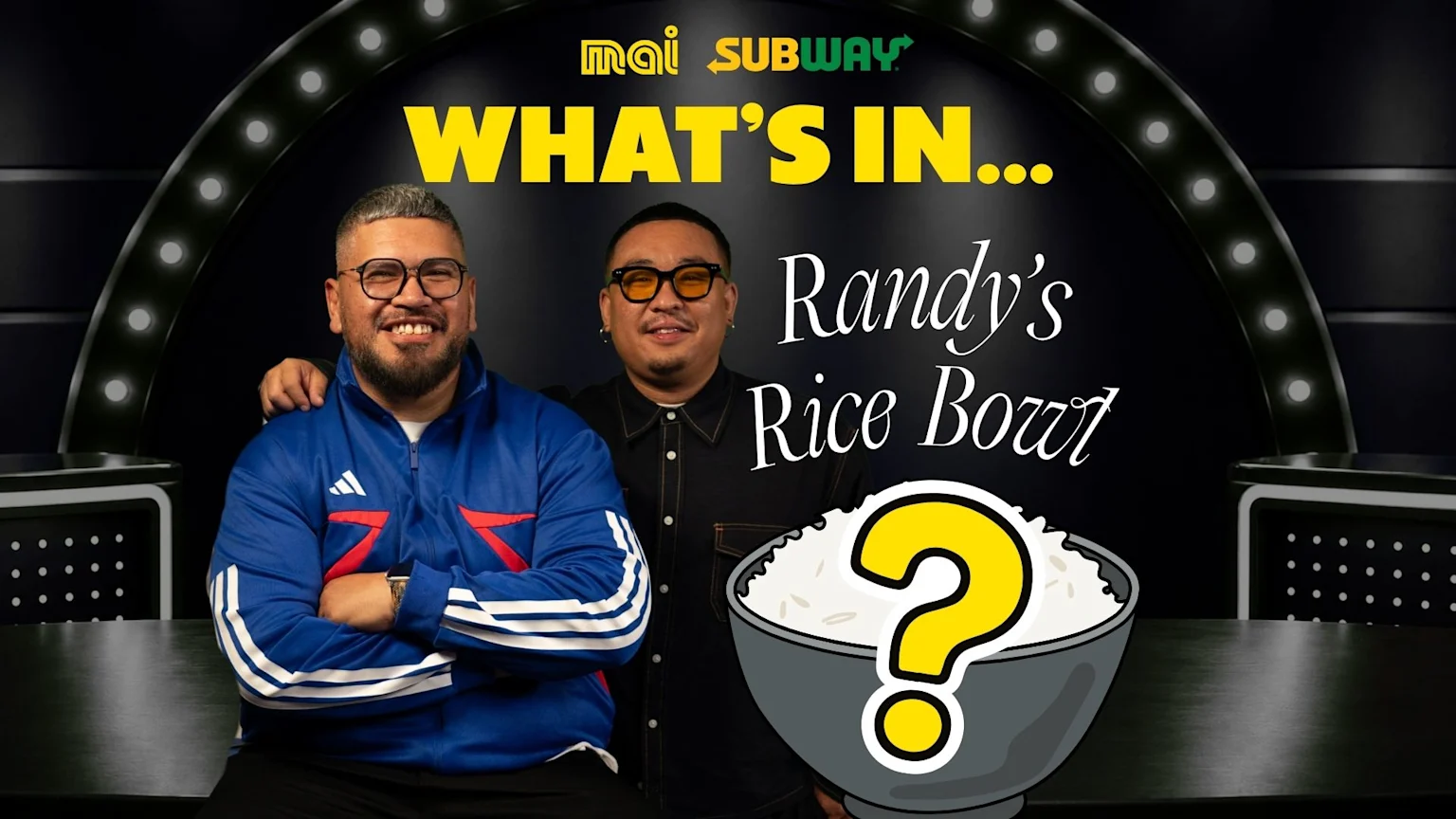 Two smiling men on a game show set with Mai and Subway logos, featuring text 'WHAT'S IN... Randy's Rice Bowl' and a cartoon rice bowl with a question mark.