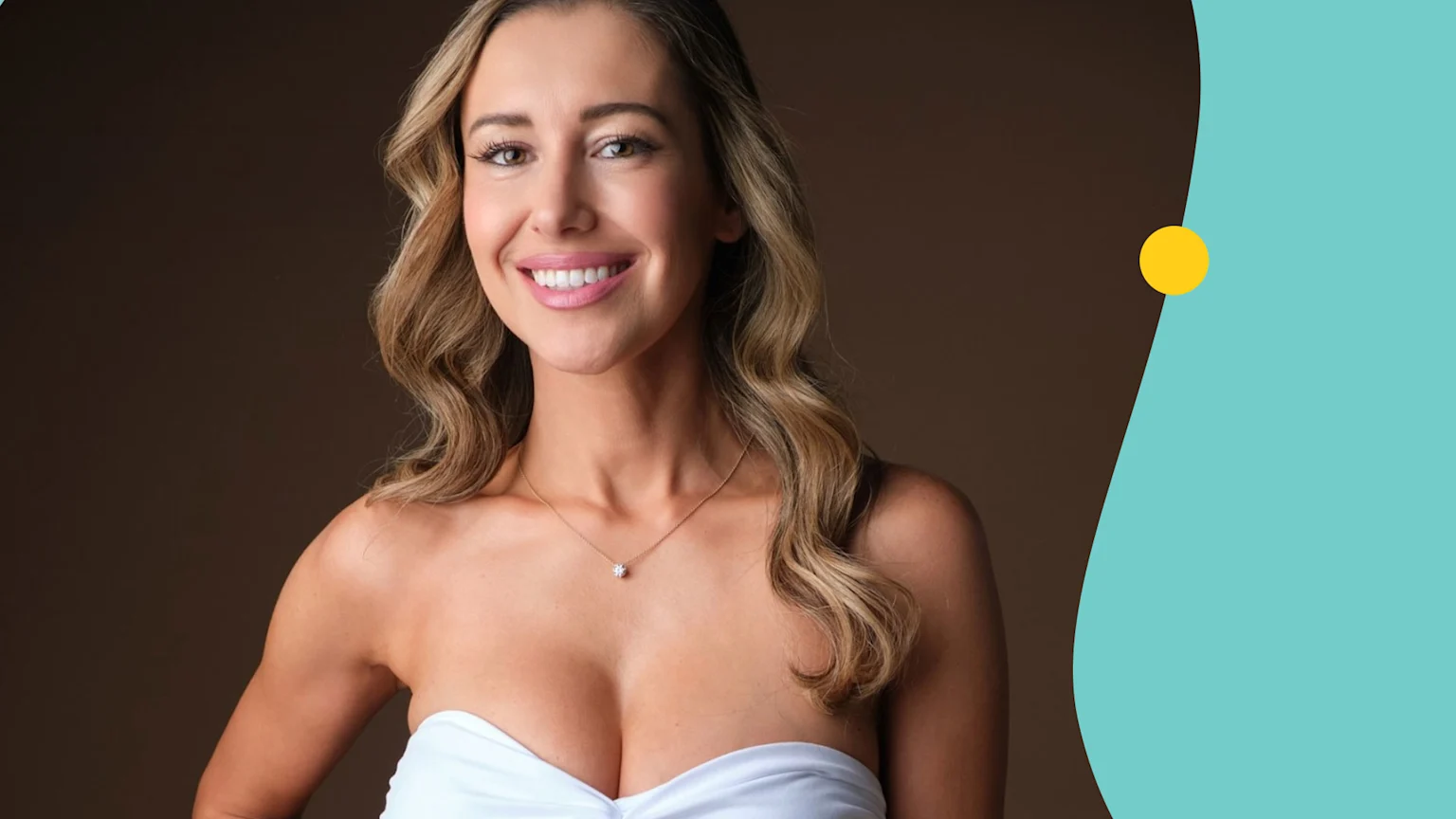 A smiling woman with long wavy blonde hair, wearing a white strapless top and a delicate necklace, looks confidently at the camera against a brown and teal background.
