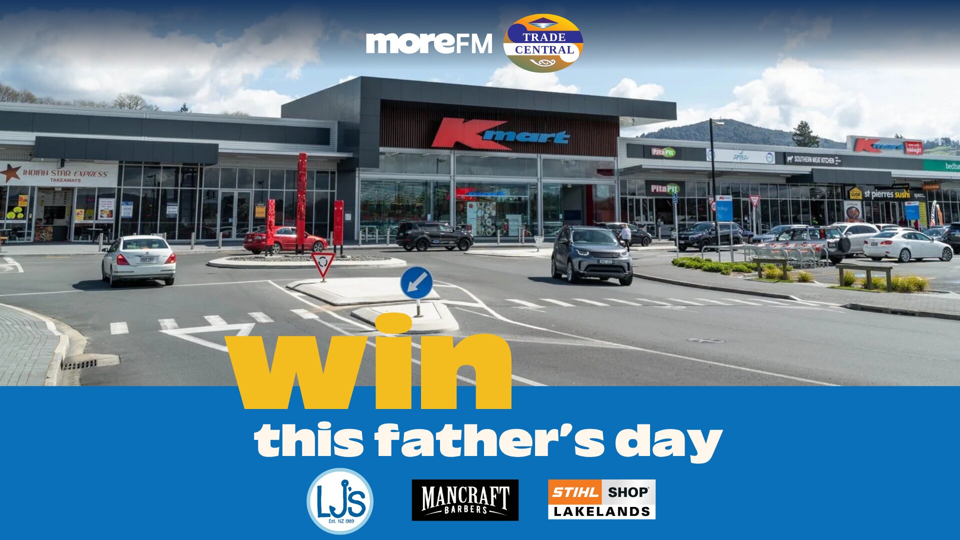 A shopping center featuring Kmart, other stores, and cars, with "win this father's day" text and logos for moreFM, Trade Central, LJ's, Mancraft Barbers, and Stihl Shop Lakelands.