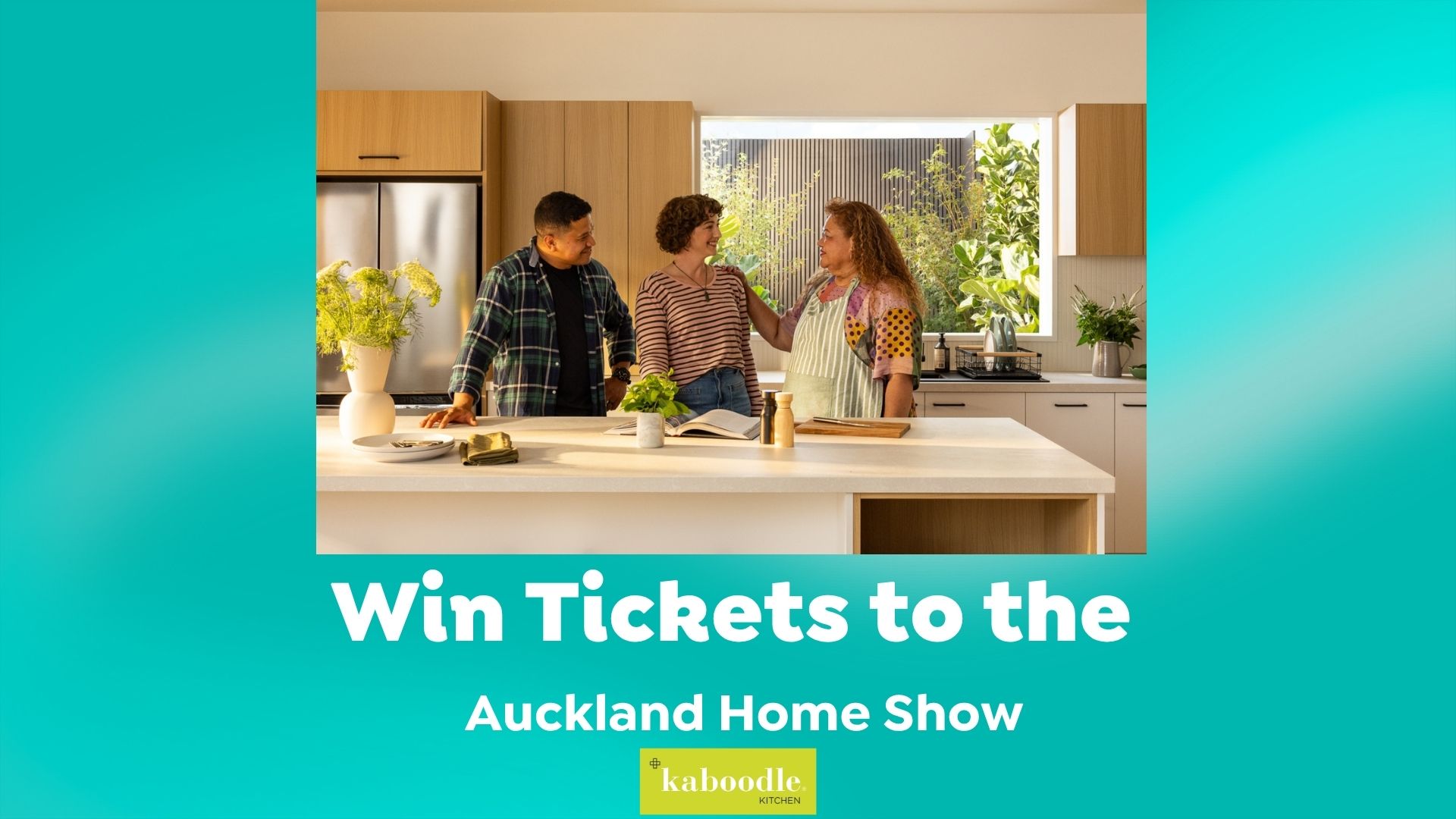Three people are interacting in a bright, modern kitchen, standing around an island with plants and a book, while promotional text below offers tickets to the Auckland Home Show with the Kaboodle Kitchen logo.