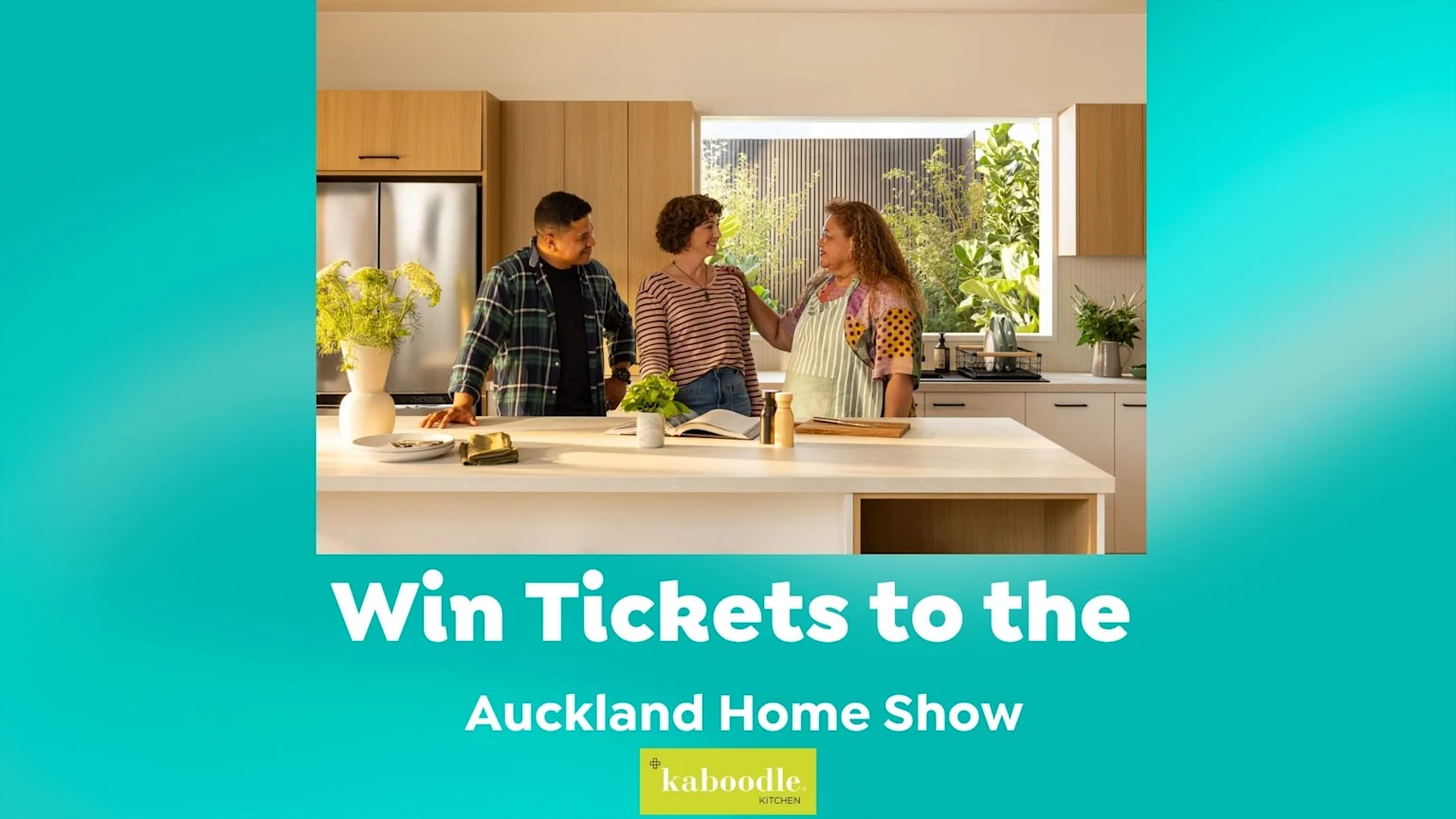 Three people are interacting in a bright, modern kitchen, standing around an island with plants and a book, while promotional text below offers tickets to the Auckland Home Show with the Kaboodle Kitchen logo.