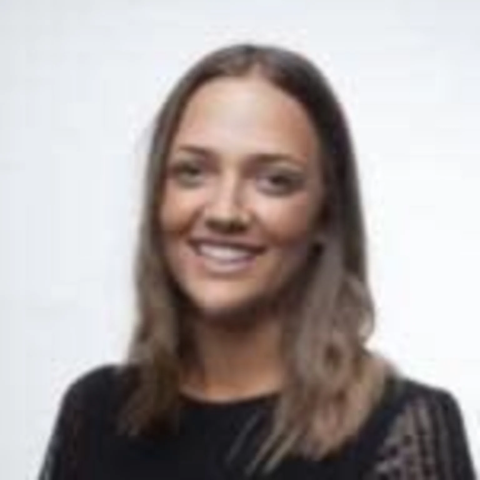 Woman with long hair smiling at camera