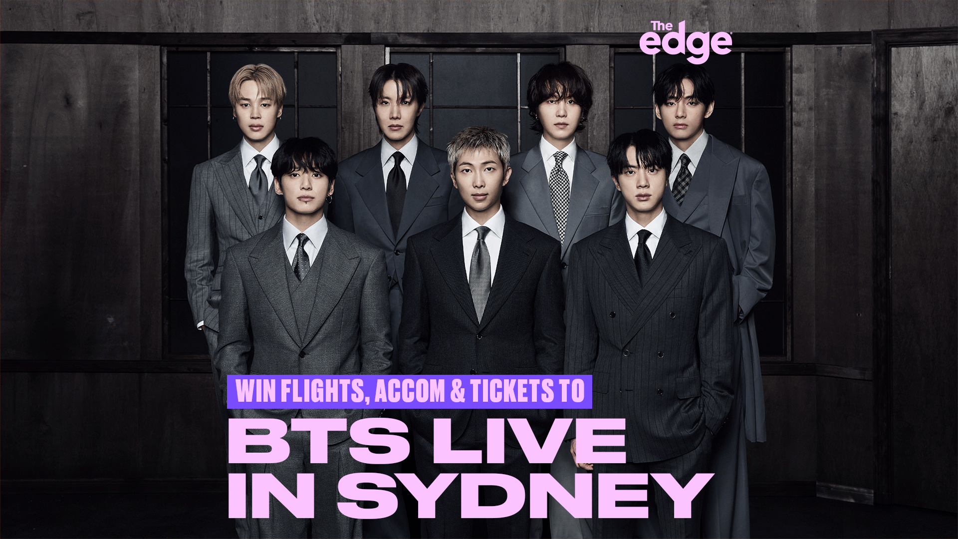Seven members of the K-pop group BTS, dressed in suits, stand in a dark room, with promotional text for 'BTS LIVE IN SYDNEY'.