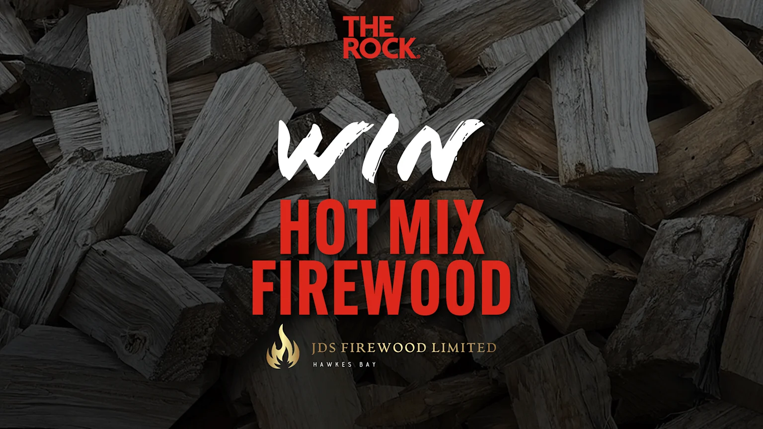 An image of stacked firewood with text overlay: 'THE ROCK WIN HOT MIX FIREWOOD' and a golden flame logo followed by 'JDS FIREWOOD LIMITED HAWKES BAY'.