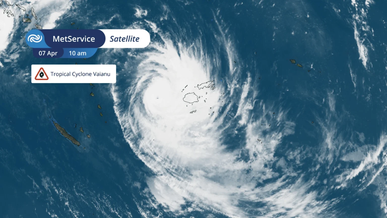 A satellite image displays Tropical Cyclone Vaianu as a large swirling mass of white clouds with a clear eye, positioned over the ocean near the islands of Fiji on 07 April at 10 am.