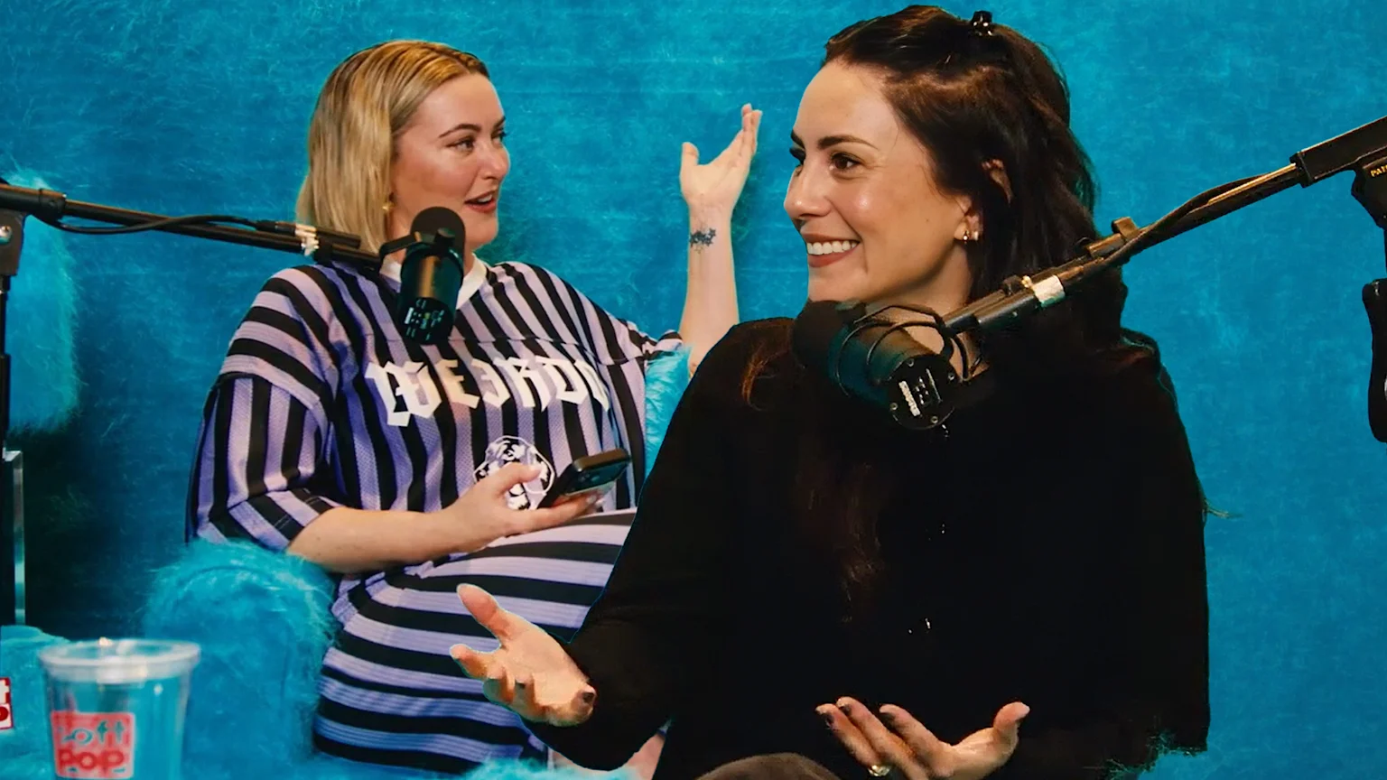 Sharyn Casey and Amy Shark talking on podcast microphones