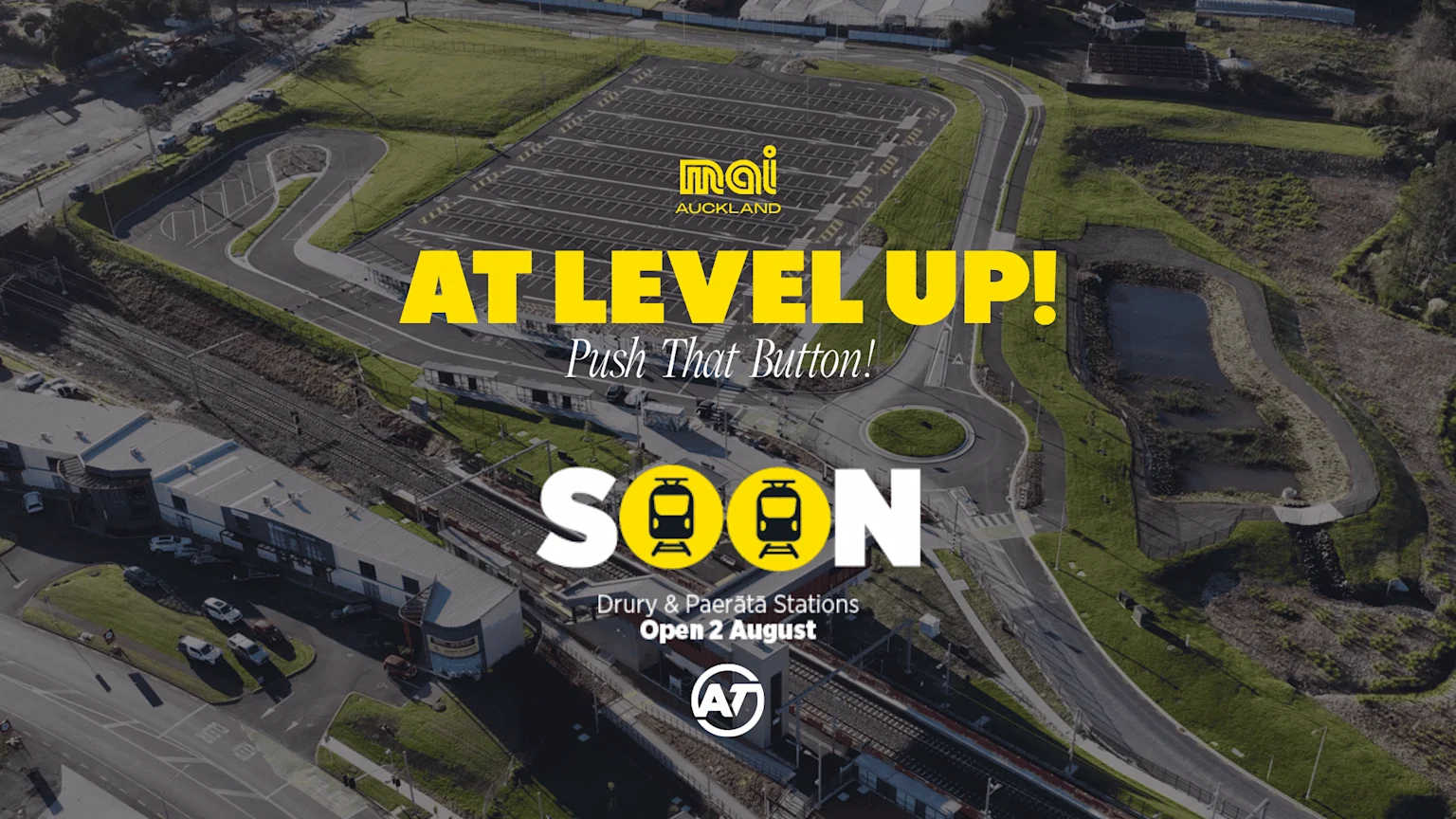 An aerial view displays a modern train station, tracks, and a large parking area, overlaid with yellow text 'AT LEVEL UP!' and 'SOON Drury & Paerata Stations Open 2 August', featuring train icons.
