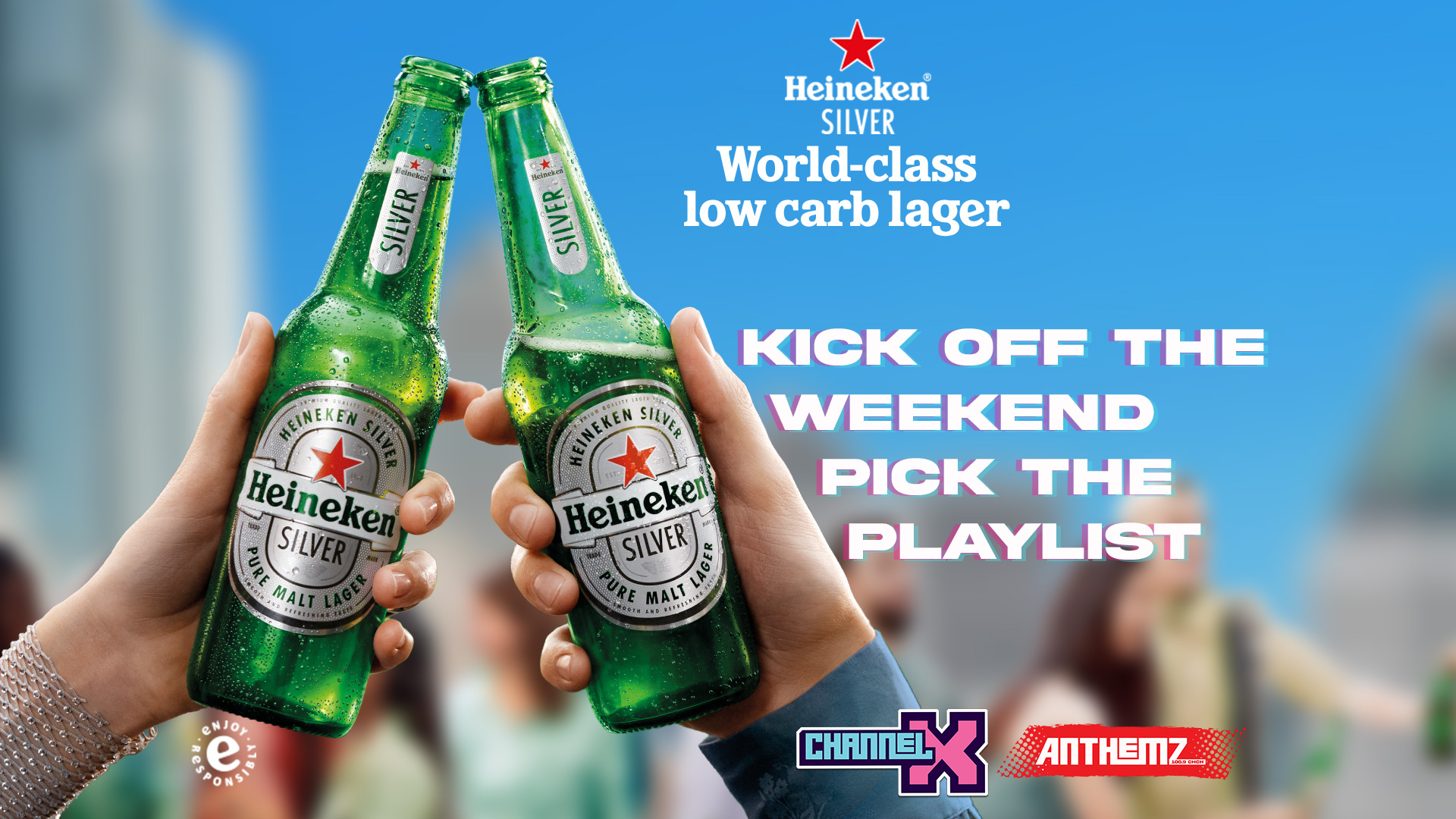 Two hands clink two cold, green Heineken Silver beer bottles with condensation, against a blurred background, with text "KICK OFF THE WEEKEND PICK THE PLAYLIST" and "CHANNEL X" and "ANTHEMZ" logos.