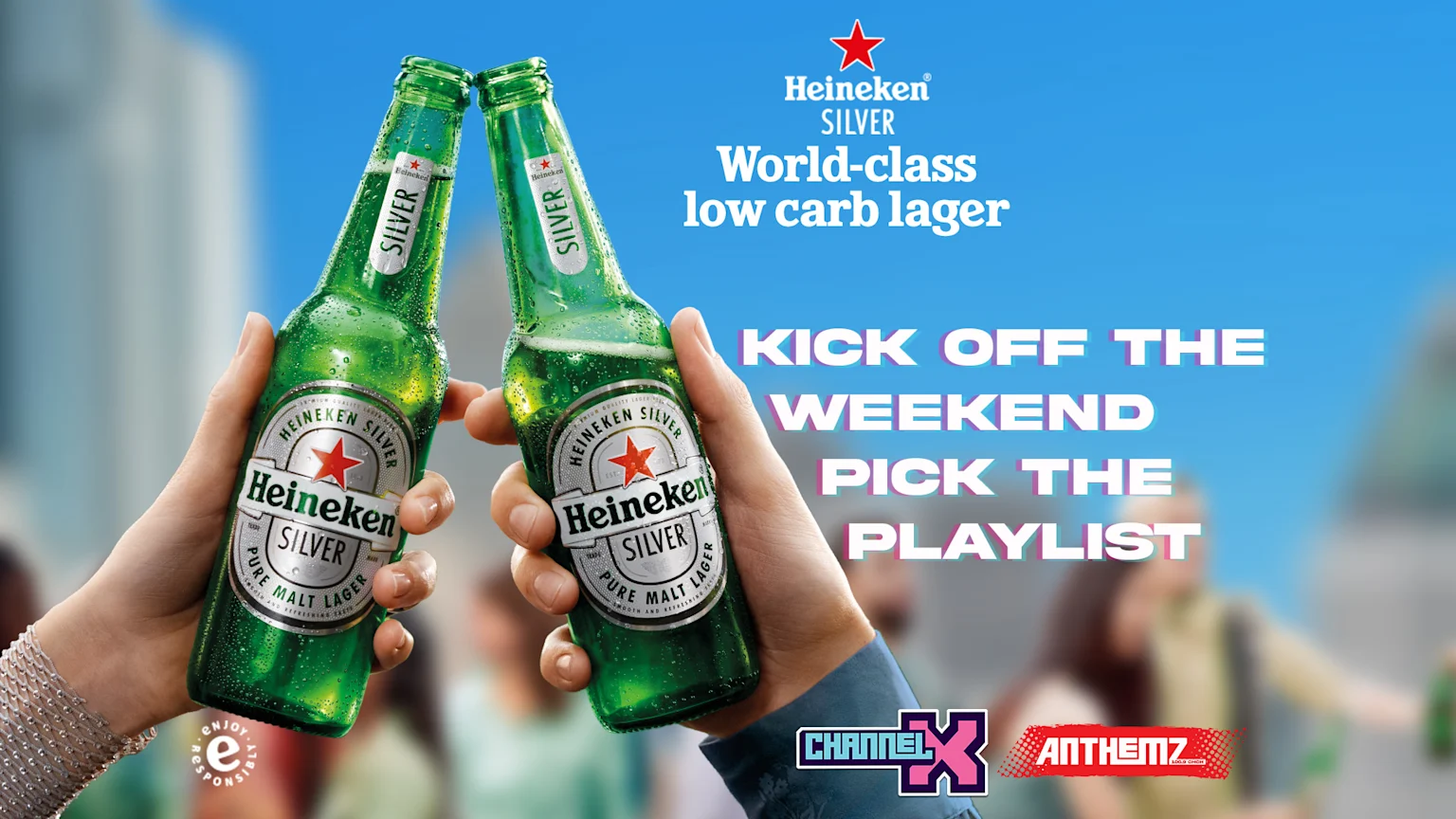 Two hands clink two cold, green Heineken Silver beer bottles with condensation, against a blurred background, with text "KICK OFF THE WEEKEND PICK THE PLAYLIST" and "CHANNEL X" and "ANTHEMZ" logos.