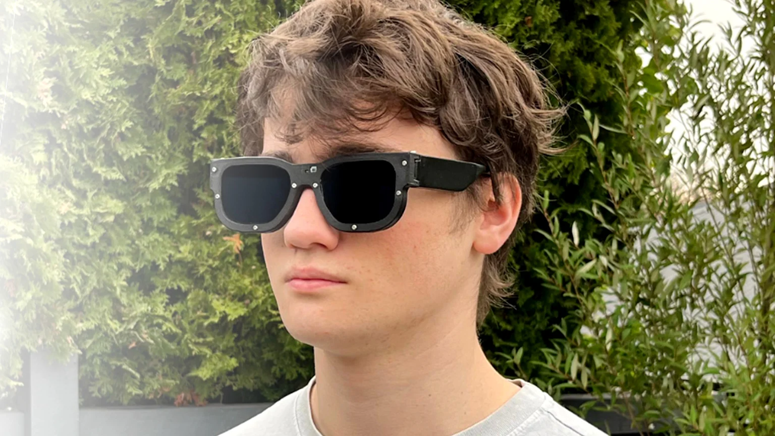 19-year-old Mark Campbell wearing Lensare sunglasses - smart glasses that detect harmful light patterns and instantly darken, protecting people with photosensitive epilepsy and photophobia from light-triggered seizures, migraines and other serious health risks.