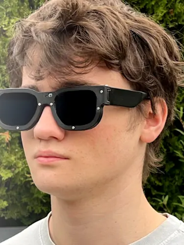 19-year-old Mark Campbell wearing Lensare sunglasses - smart glasses that detect harmful light patterns and instantly darken, protecting people with photosensitive epilepsy and photophobia from light-triggered seizures, migraines and other serious health risks.