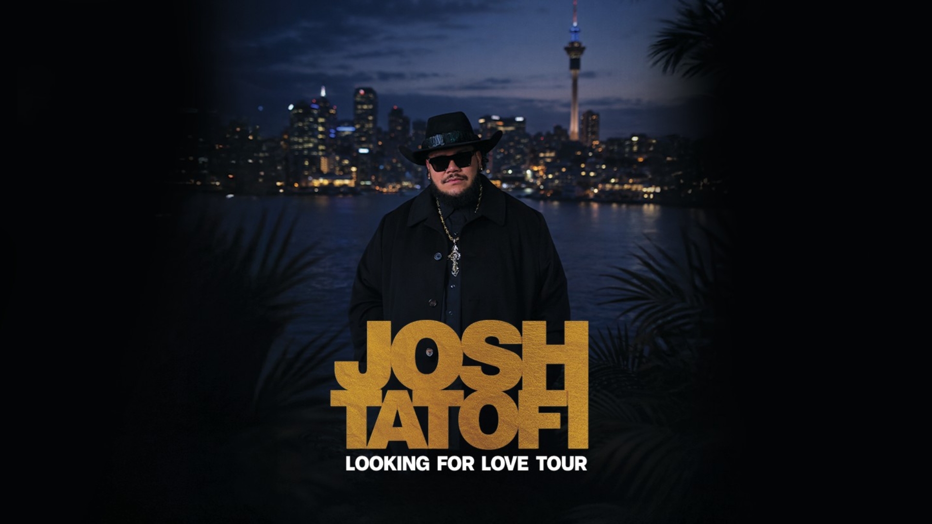 A man in a hat and sunglasses stands in front of an illuminated Auckland cityscape at night, with the text "JOSH TATOFI LOOKING FOR LOVE TOUR" in gold letters below him.