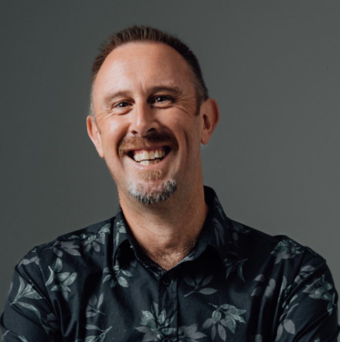 Person smiling in floral print shirt