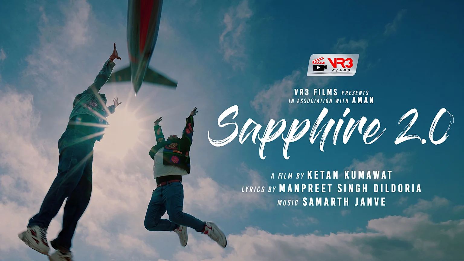 Two people jump towards an airplane in a bright, cloudy sky, with the title "Sapphire 2.0" and credits including Ketan Kumawat and Manpreet Singh Dildoria.