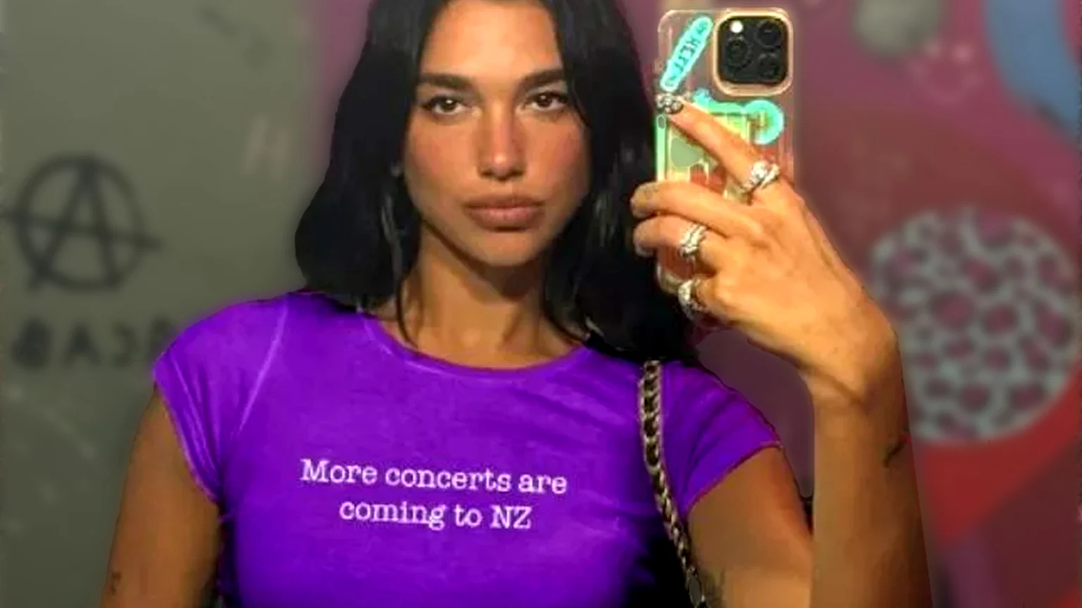 Dua Lipa edited to wear a purple shirt that reads: "More concerts are coming to NZ".