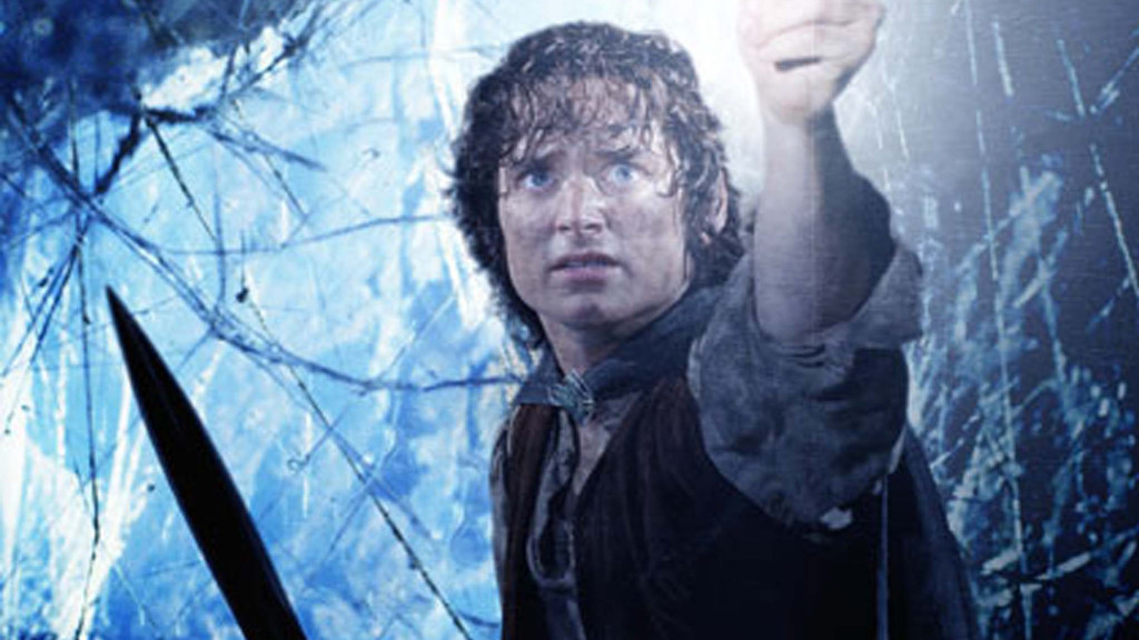 Elijah Wood as Frodo Baggins, wide-eyed and fearful, holds up a glowing object against a swirling blue background, with the tip of a dark sword in the foreground.