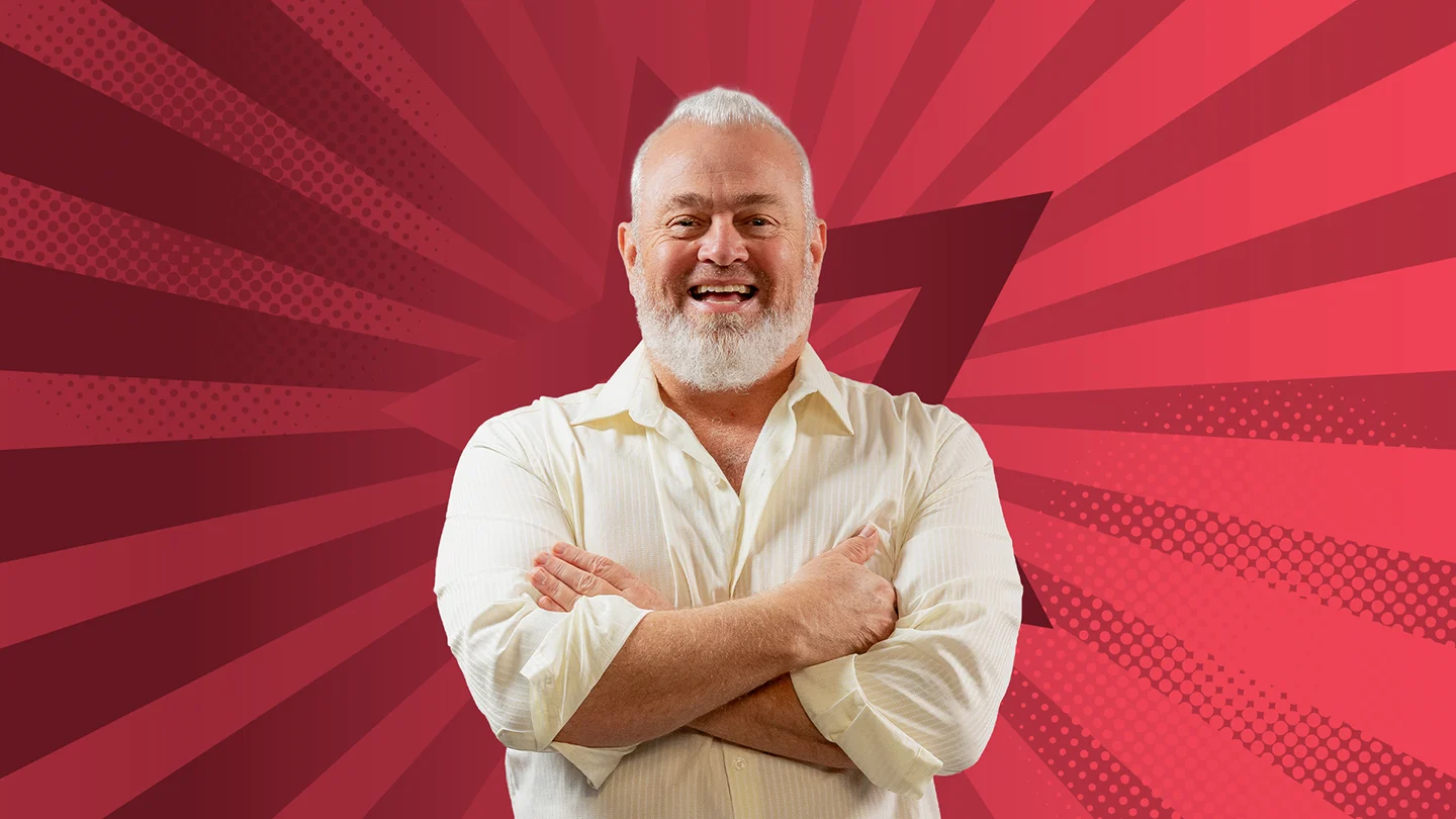 Mark McCarron smiling against a starry red background