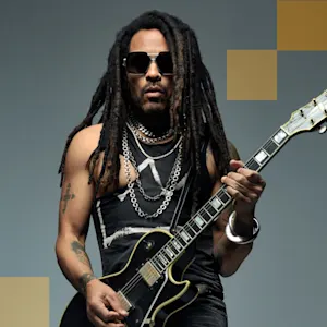 Lenny Kravitz wearing sunglasses and holding an electric guitar