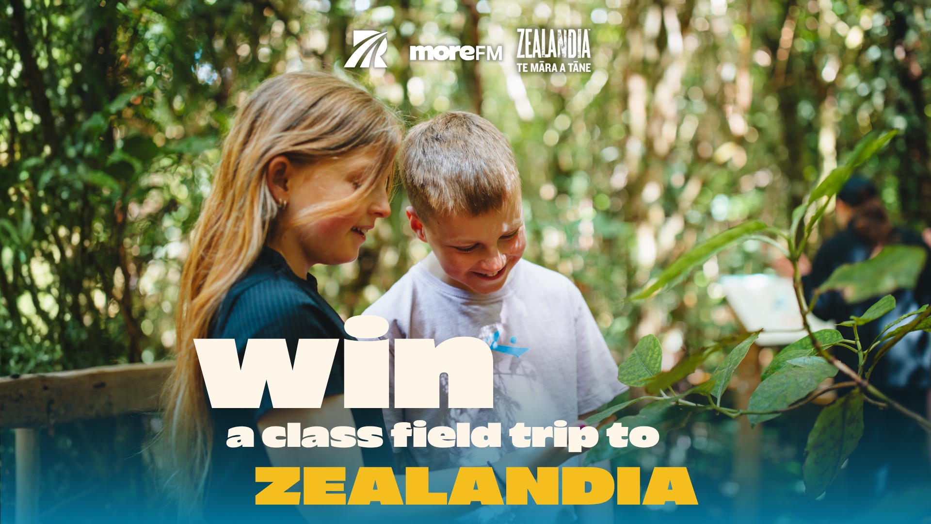 Two smiling children look down at something in a lush green outdoor environment, with overlaid text promoting "Win a class field trip to ZEALANDIA."