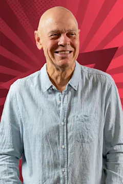 John Markby smiling against a starry red background