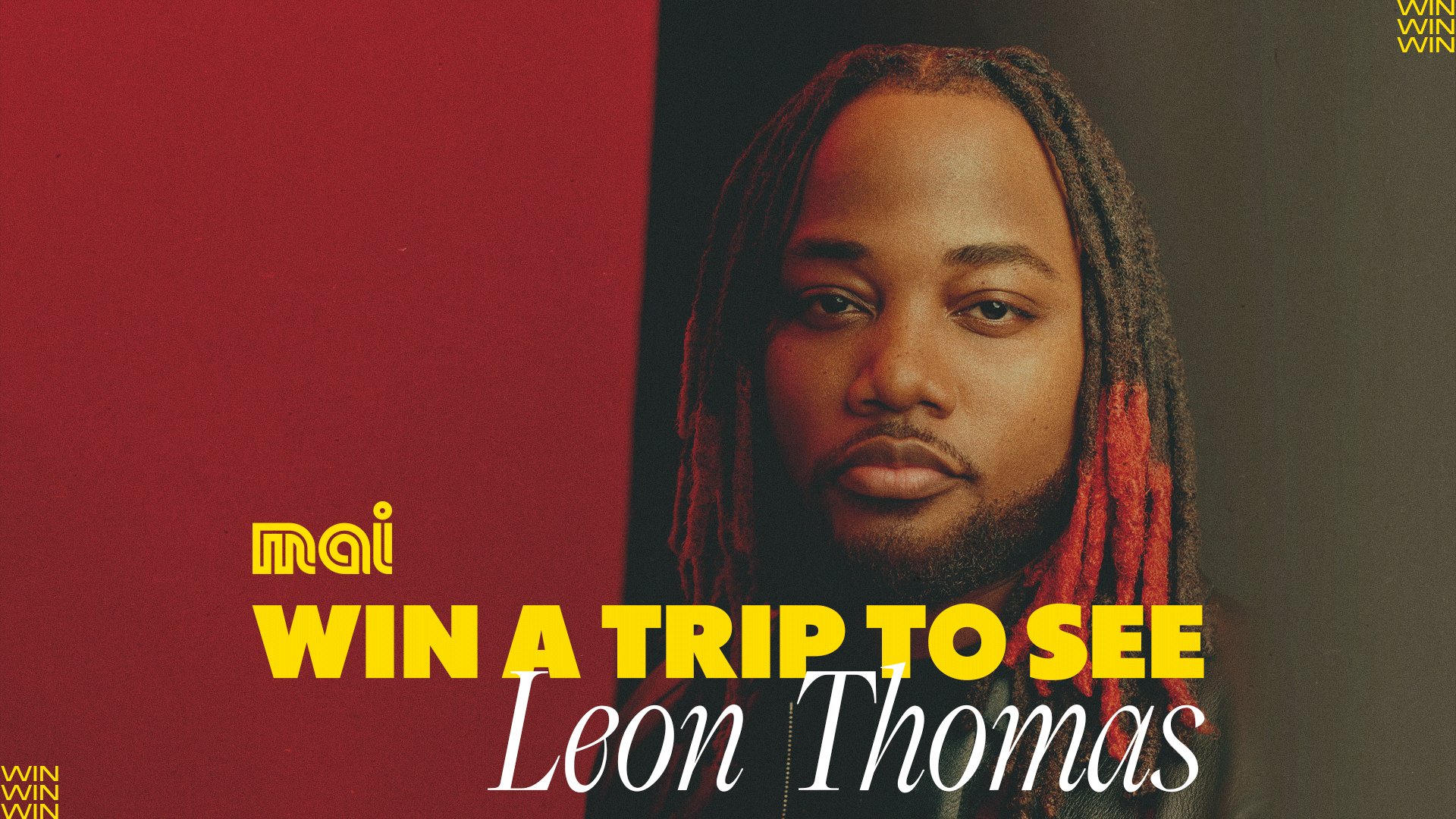 A portrait of singer Leon Thomas looking at the camera, with the prominent text "WIN A TRIP TO SEE Leon Thomas" over a split red and dark background.
