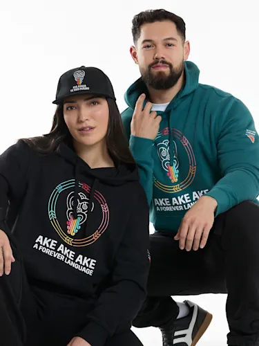 Two people wearing Māori language week hoodies