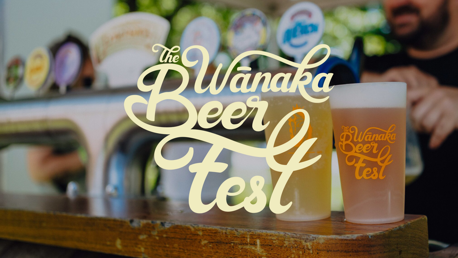 Background of two beers, "The Wanaka Beer Fest" logo centered.