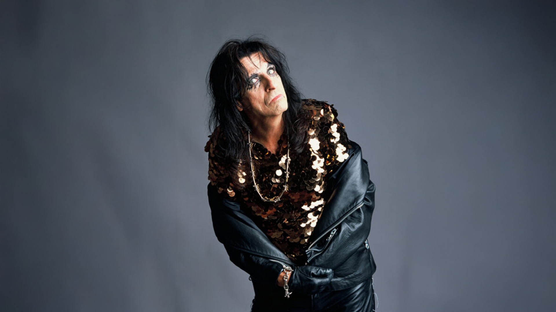 Alice Cooper poses in sequins and leather jacket