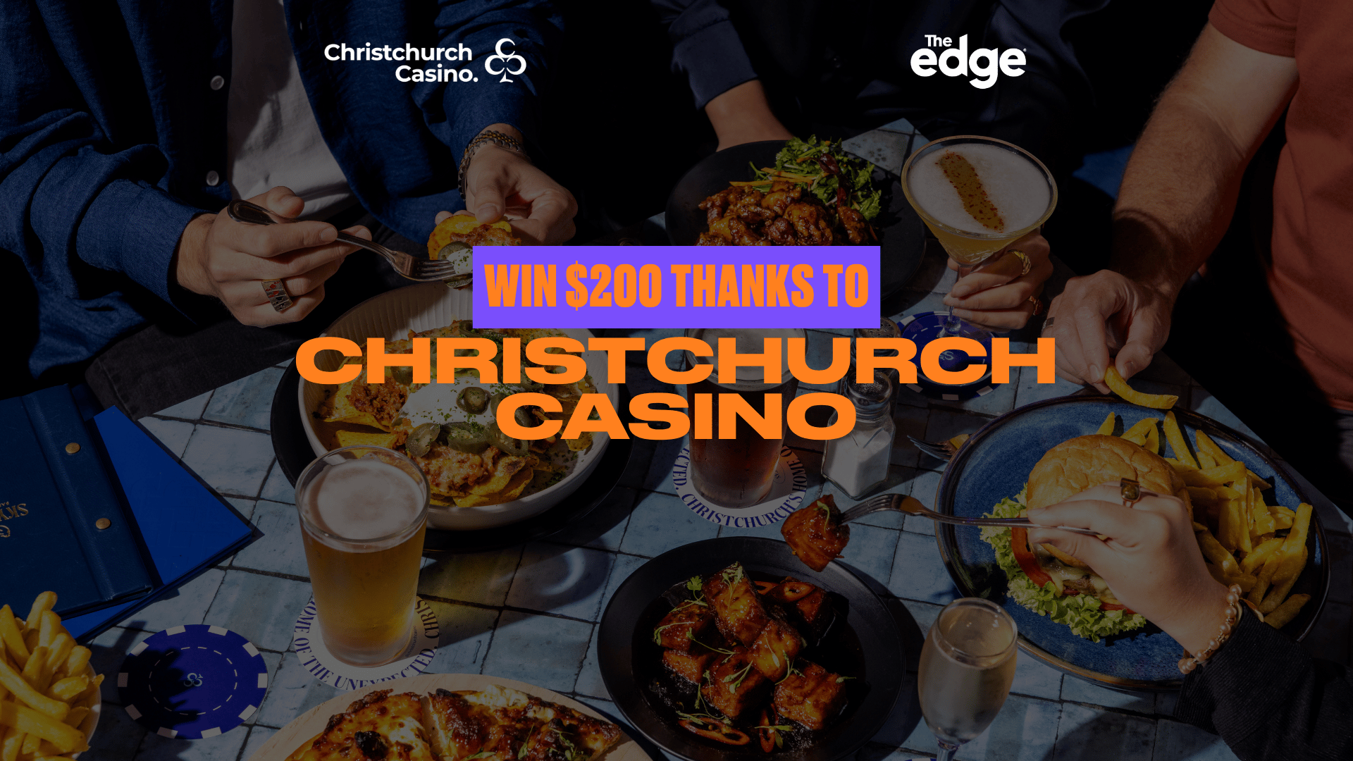 An overhead view of people sharing a meal and drinks at a table, featuring food, beverages, and prominent text "WIN $200 THANKS TO CHRISTCHURCH CASINO" along with Christchurch Casino and The Edge logos.