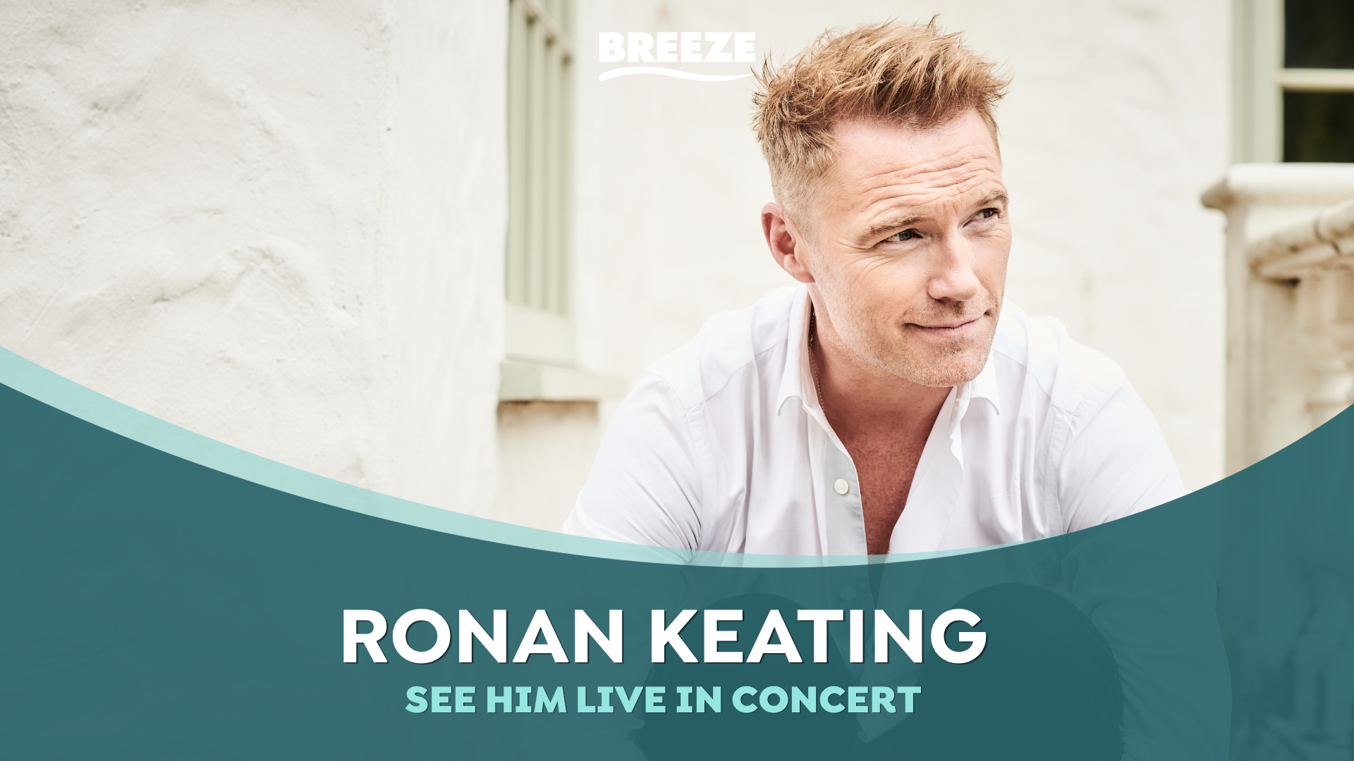 Ronan Keating, a man in a white shirt with reddish-blonde hair, smiles and looks right, with a "BREEZE" logo above and text "RONAN KEATING SEE HIM LIVE IN CONCERT" on a teal banner below.