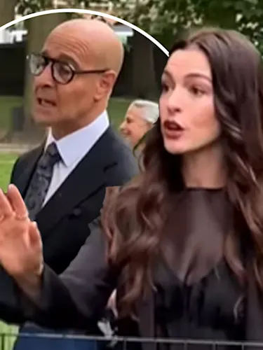 Anne Hathaway and Stanley Tucci in Central Park, New York sternly talking to Paparazzi off camera.
