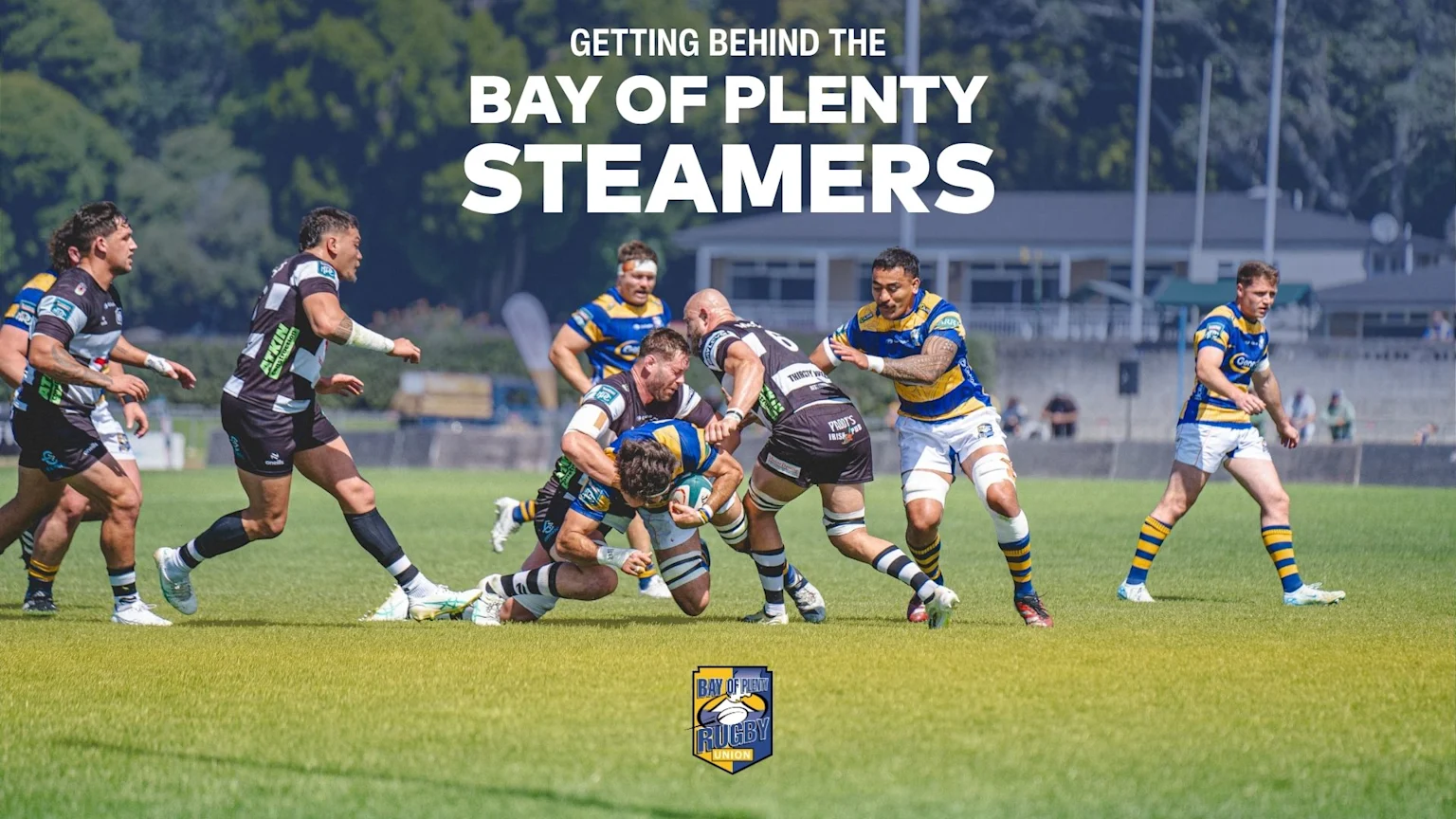 A dynamic photo shows rugby players from the Bay of Plenty Steamers tackling during a match on a sunny field, with their team logo at the bottom.