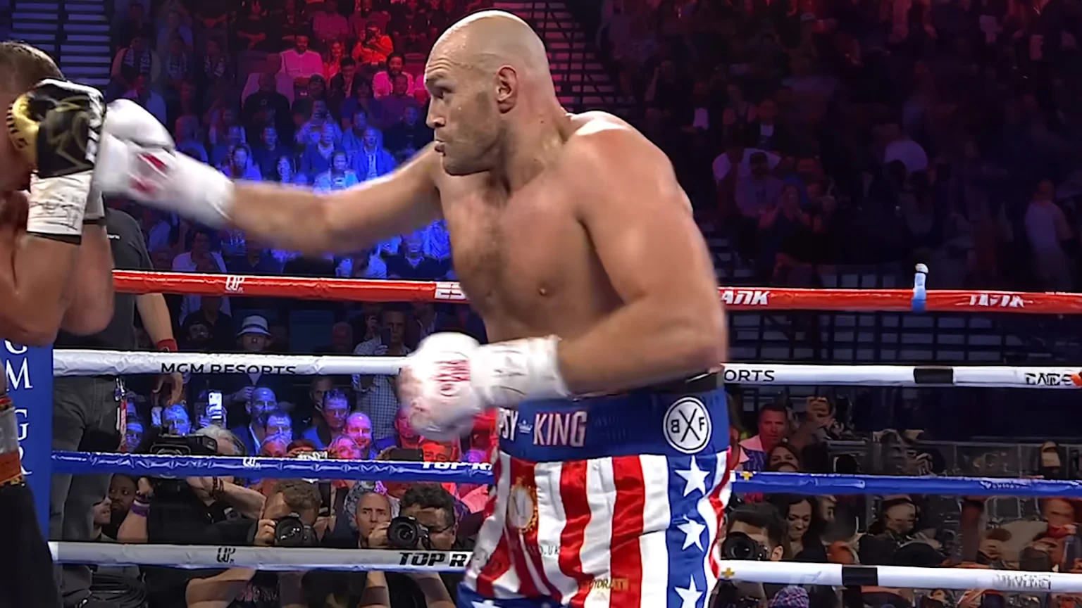 Picture of boxer Tyson Fury throwing a punch in a boxing match.