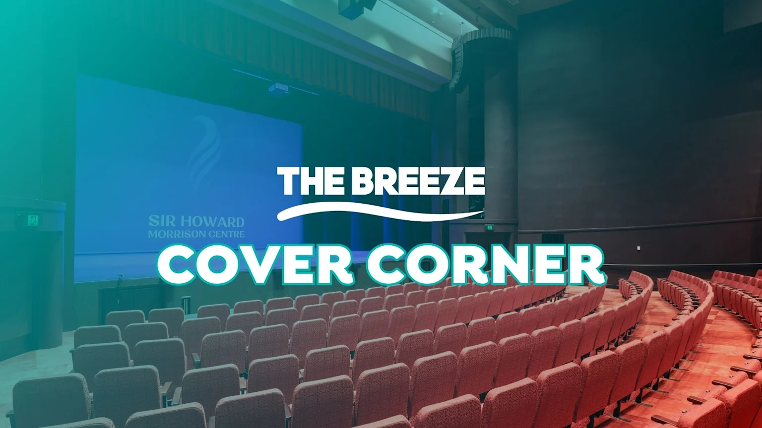 An empty auditorium with rows of reddish-brown seats facing a stage with a blue screen displaying "SIR HOWARD MORRISON CENTRE" and a logo, overlaid with text "THE BREEZE COVER CORNER".